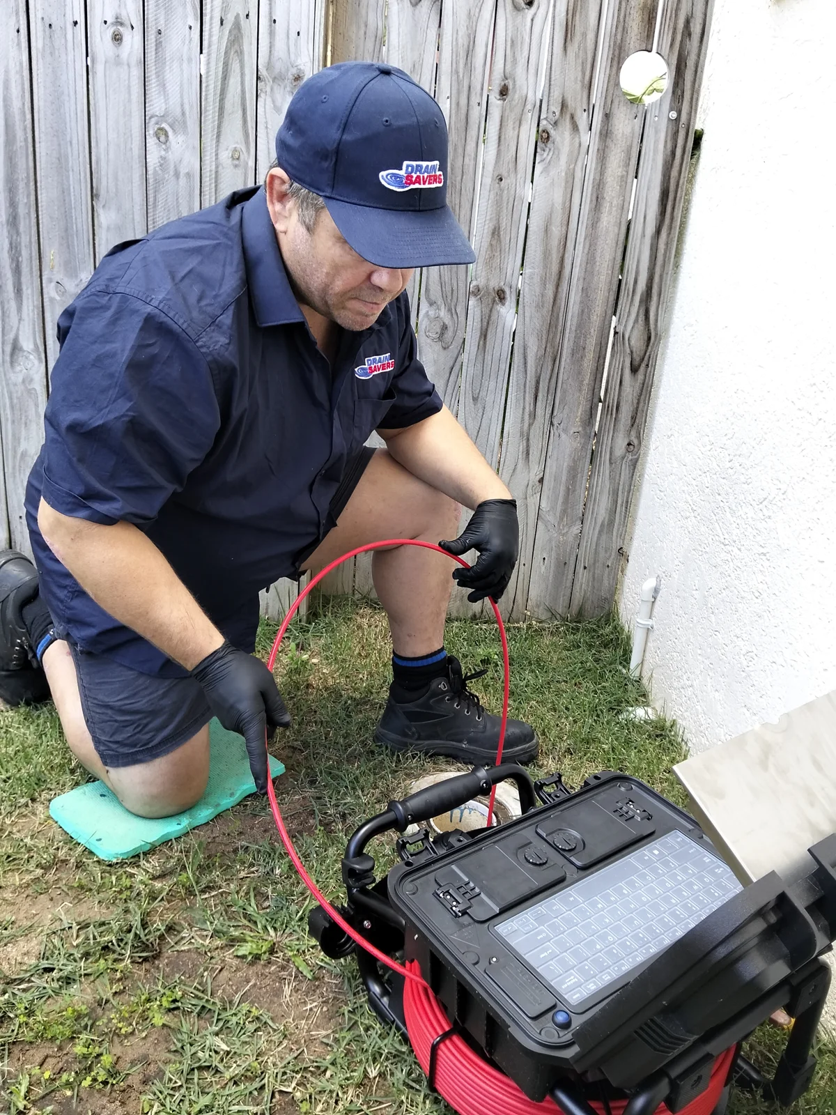 Brendon from Drain Savers Plus using a CCTV camera to inspect a drain